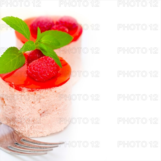 Fresh raspberry cake mousse dessert round shape with mint leaves
