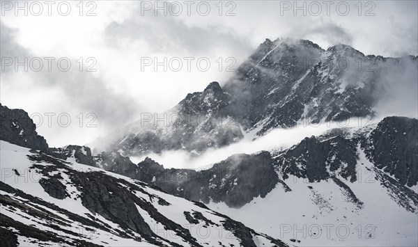 Mountains in winter with clouds and fog