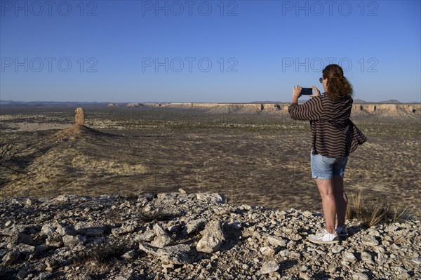 Tourist photographing the Finger Cliff