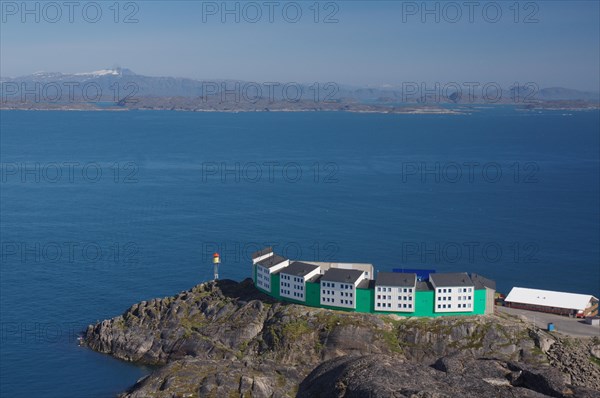 Modern residential buildings standing on rocks by the sea