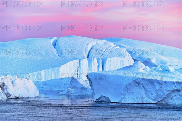 Gigantic icebergs in the light of the blue hour