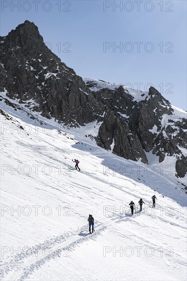 Ski tourers on the ascent in a saddle