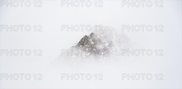 Mountains in winter with clouds and fog