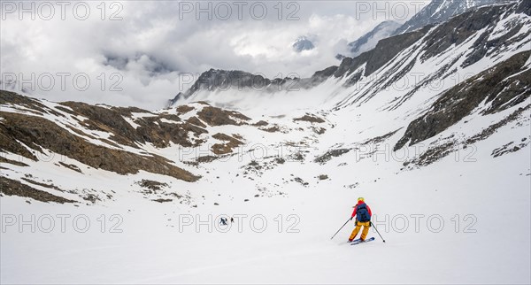 Ski tourers in winter on the descent