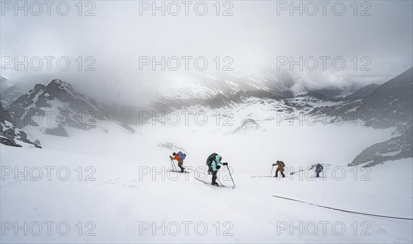 Ski tourers ascending the rope