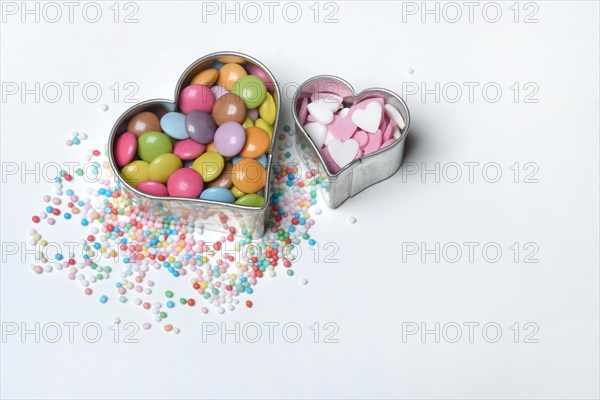 Chocolate lentils and love beads in heart-shaped cookie cutter