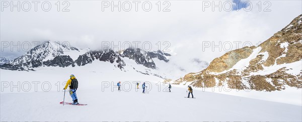 Group of ski tourers and splitboarders on the descent at Alpeiner Ferner