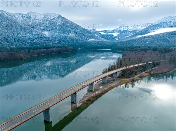 Road with bridge on the water in winter