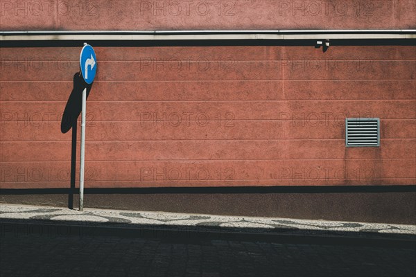 Empty street with blue road sign