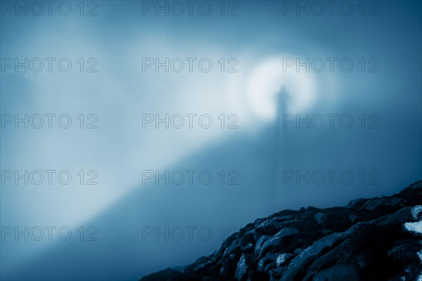Shadow cast by the photographer in the fog