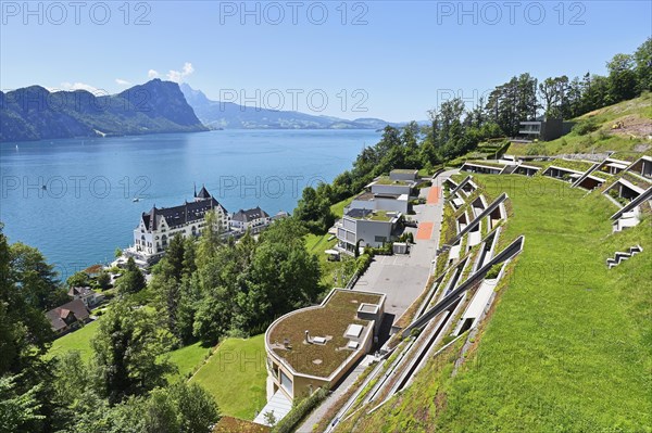 Modern earth houses built on a slope with a view of the Parkhotel and Lake Lucerne