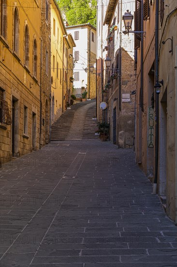 Narrow alley with pastel-coloured house facades