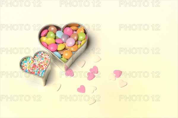 Chocolate lentils and love beads in heart-shaped cookie cutter