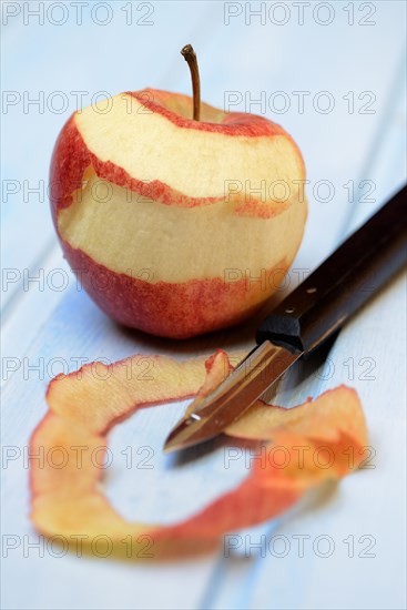 Peeled apple with peeling knife