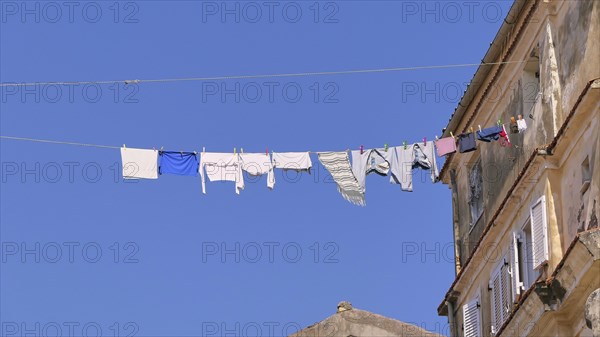 Clothesline with laundry hanging high above Old Town alley