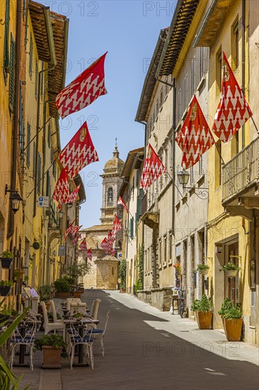 Red and white flags in the pedestrian zone of San Quirico dOrcia