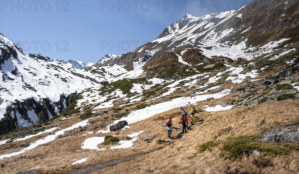 Ski tourers hiking in spring with little snow