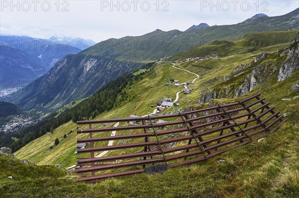 Metal avalanche barrier above the village