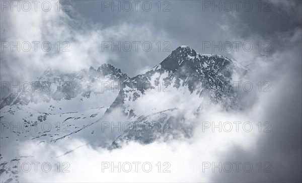 Mountains in winter with clouds and fog