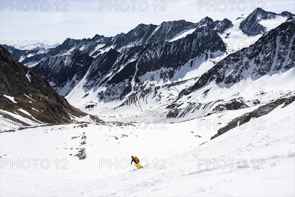 Ski tourers descending a steep slope