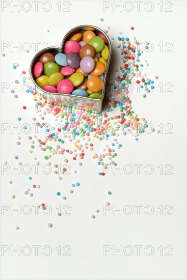 Chocolate lentils and love beads in heart-shaped cookie cutter