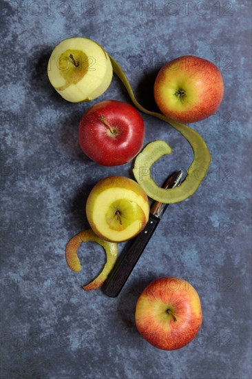 Peeled apples with peeling knife