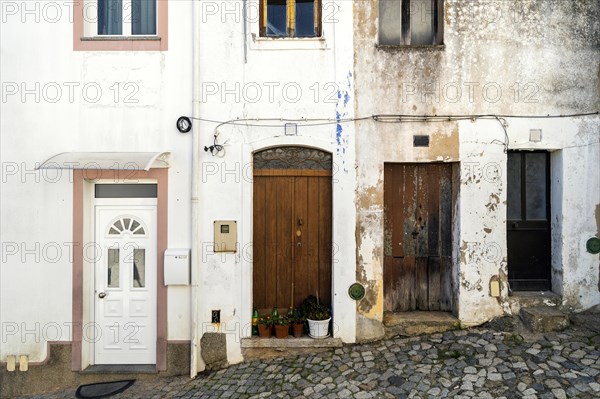 Four doors in whitewashed houses of mountainous Monchique