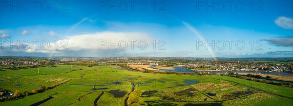 Rainbow at Sunrise over RSPB Exminster and Powderham Marshes from a drone in panorama