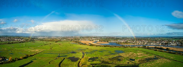 Rainbow at Sunrise over RSPB Exminster and Powderham Marshes from a drone in panorama