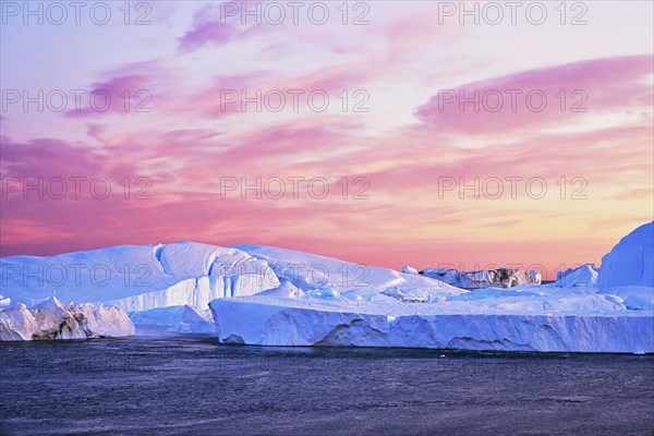 Gigantic icebergs in the evening light