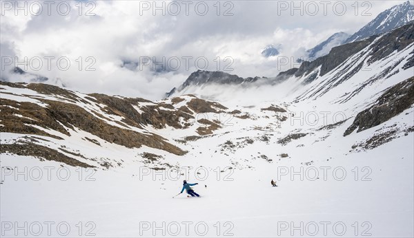 Ski tourers in winter on the descent