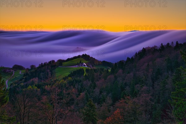 Wave of fog in front of sunrise over the Jura Mountains of Basel-Landschaft