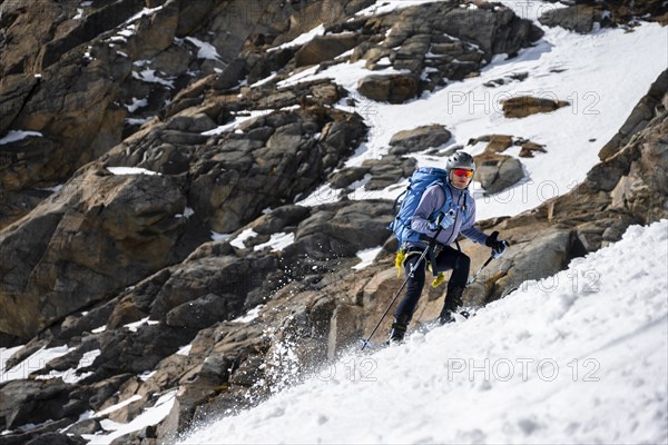 Ski tourers descending a steep slope