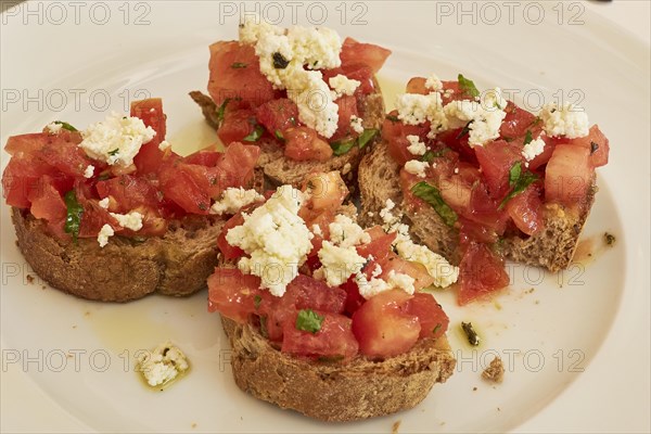 Plate of bruschetta with tomatoes and feta