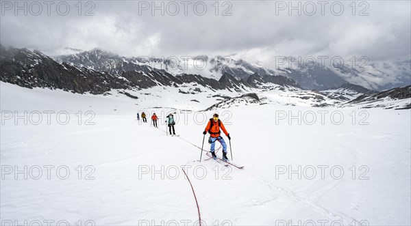 Ski tourers ascending the rope