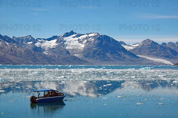 Icebergs reflected in a fjord