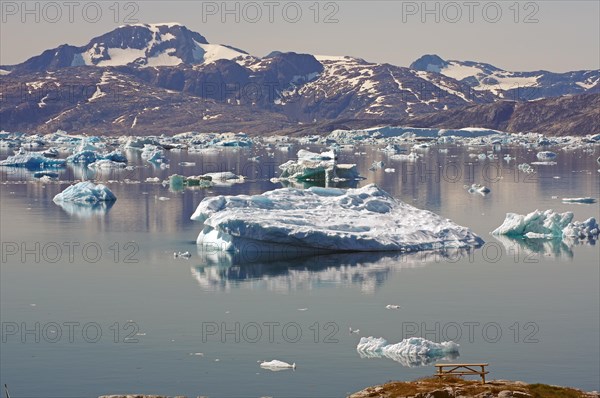 Icebergs reflected in a fjord