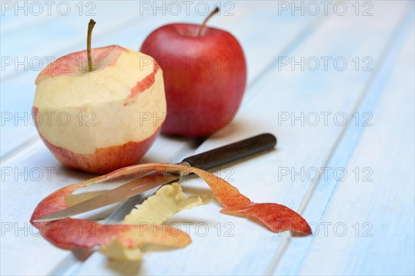 Peeled apple with peeling knife