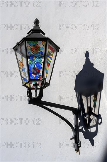 Colourfully painted lantern with shadow