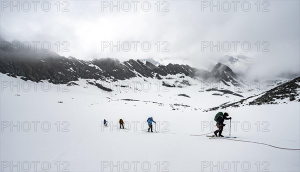 Ski tourers ascending the rope