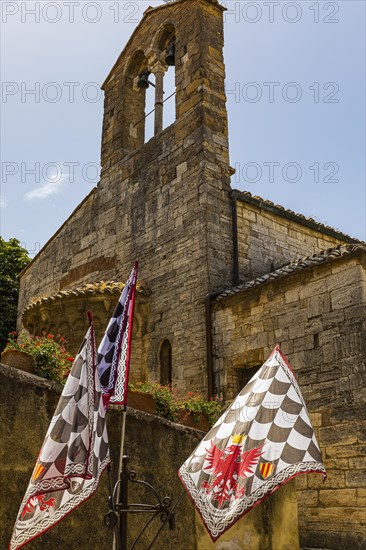 Brown and white flags at the church of Santa Maria Assunta
