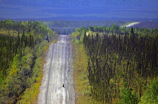 Cyclist on an endless dirt road