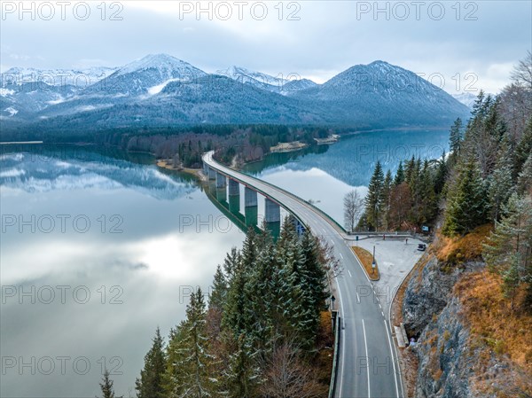 Road with bridge on the water in winter