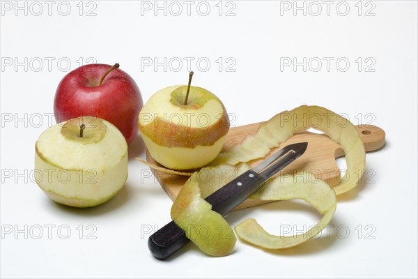 Peeled apples with peeling knife