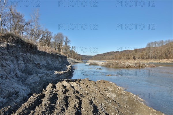 Worn river bank and filled gravel bank