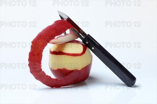 Peeled apple with peeling knife