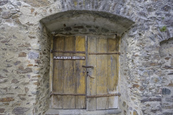 Posting Prohibited sign on old wooden door