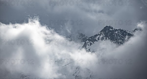 Mountains in winter with clouds and fog