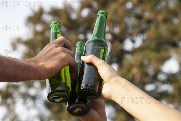 Toasting with beer bottles