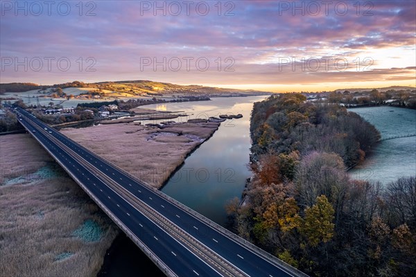 Sunrise over Bridge and Marshland of River Teign shrouded in frost from a drone